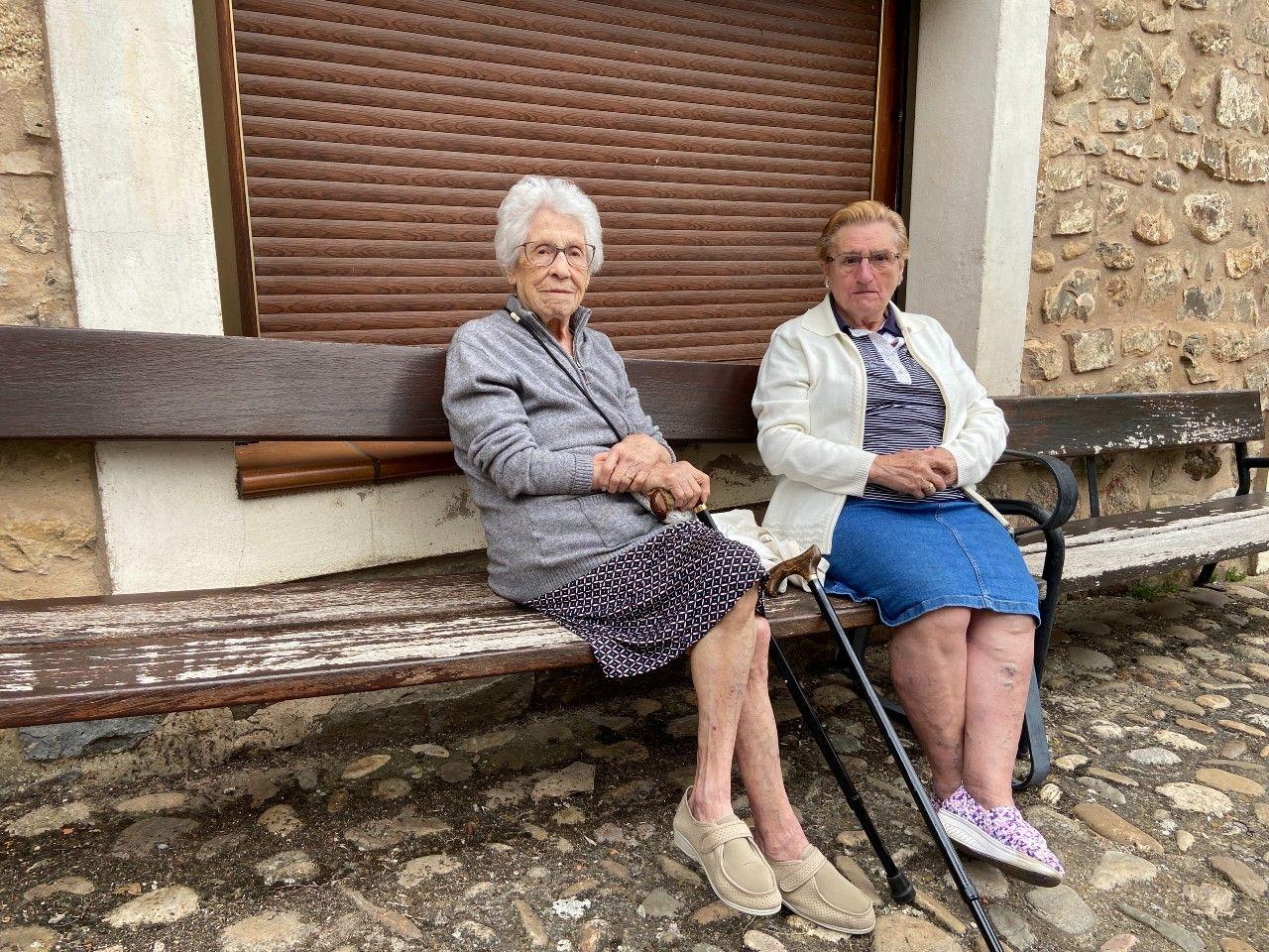 Charo y Amalia sentadas en un banco en Villoslada. 